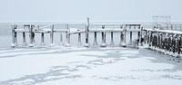Snow and ice on the old fishing pier in Polson, MT, on Flathead Lake